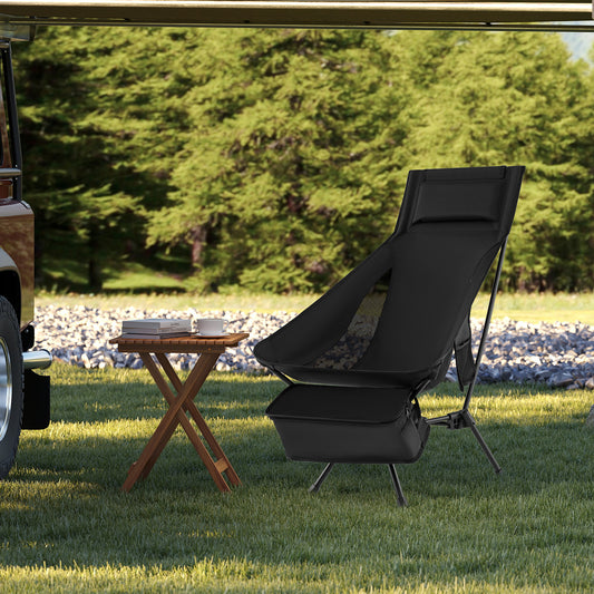 The camping chair set up next to a small wooden table on a grassy area with a vehicle nearby