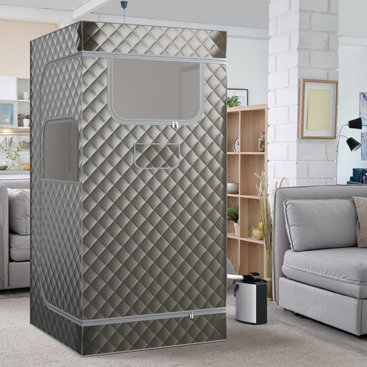 The portable sauna set up in a living room next to a sofa and wooden shelving unit