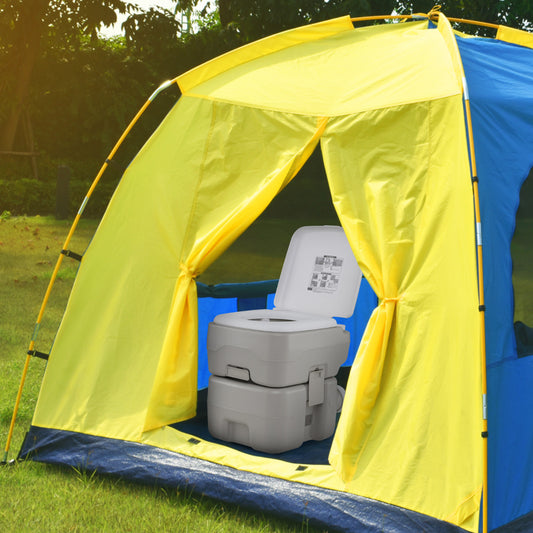 The camping toilet set up inside a blue and yellow tent on grass