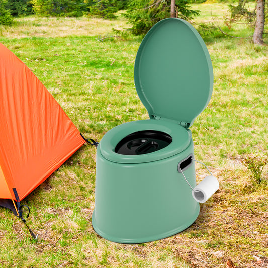 The camping toilet in green next to an orange tent in a grassy outdoor setting