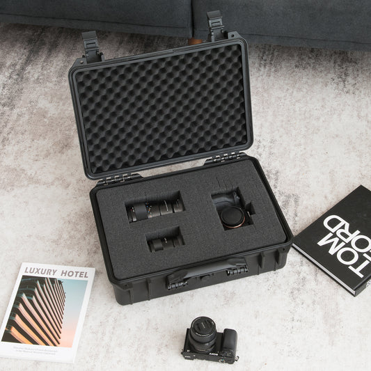 The hard case is shown with a camera and lenses inside, on a table