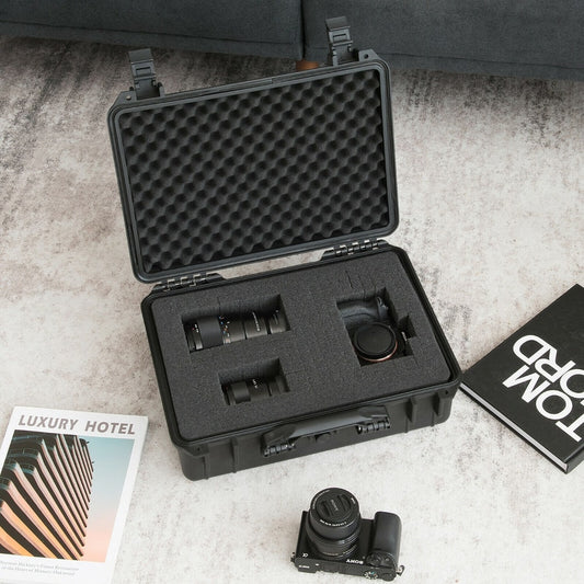 The camping case holds a camera and lenses inside its foam insert