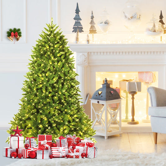 The christmas tree decorated with lights and surrounded by wrapped gifts in a living room