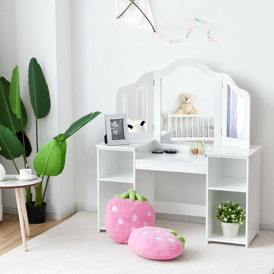 The kids vanity table is shown in a child's bedroom with pink strawberry cushions and a teddy bear