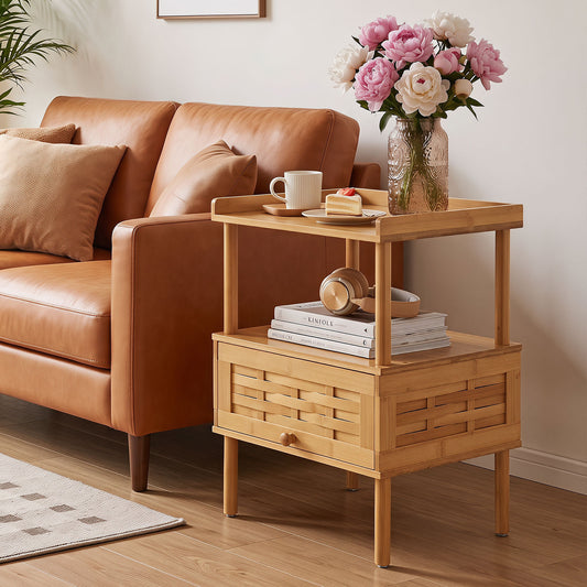 The bamboo rattan nightstand is shown next to a sofa with a book and vase on top
