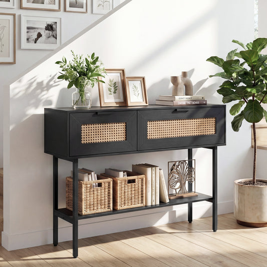 Black console table with cane detailing in a hallway setting with baskets and plants