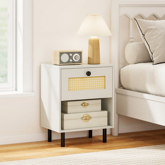 White bedside table with a drawer and open shelf next to a bed