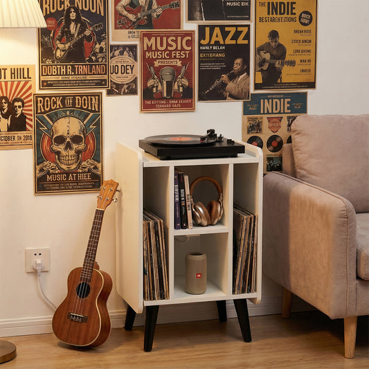 The record player stand in a living room with a ukulele and posters