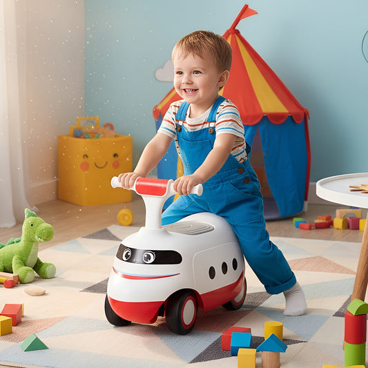 A happy toddler rides the white push car with red accents in a playroom