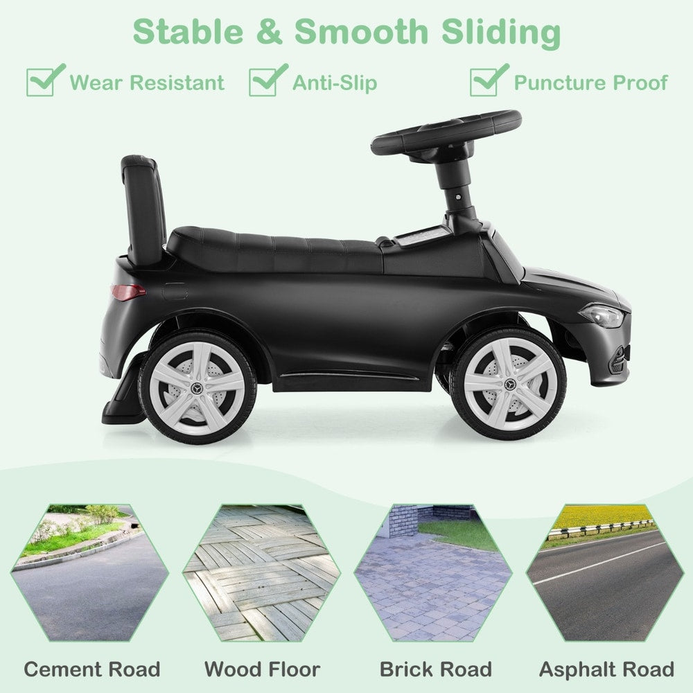 Black push and pedal ride on toy shown from the side, suitable for various surfaces