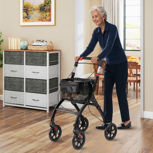 A woman uses the black walker with tray indoors, walking down a hallway