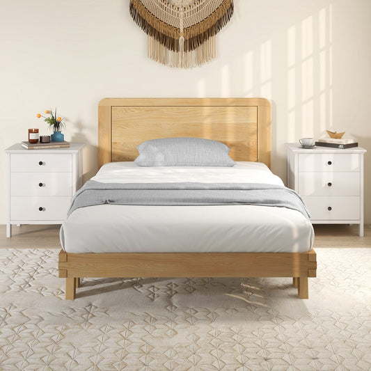 Two white bedside tables flanking a bed in a bedroom setting