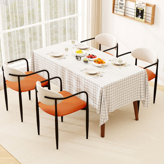Four dining chairs around a table set for a meal in a dining room