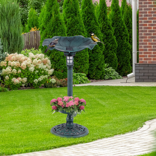 Antique bird bath and feeder set with two birds perched on the edge, placed on a green lawn
