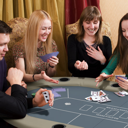 Four people playing poker at the folding poker table with cup holders
