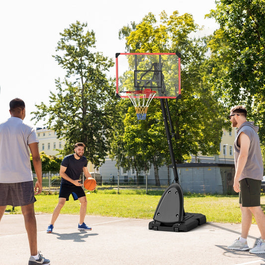 Three men playing basketball with the portable hoop and stand on an outdoor court