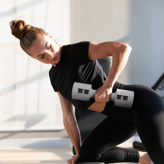 Woman using an adjustable dumbbell for a workout on a bench