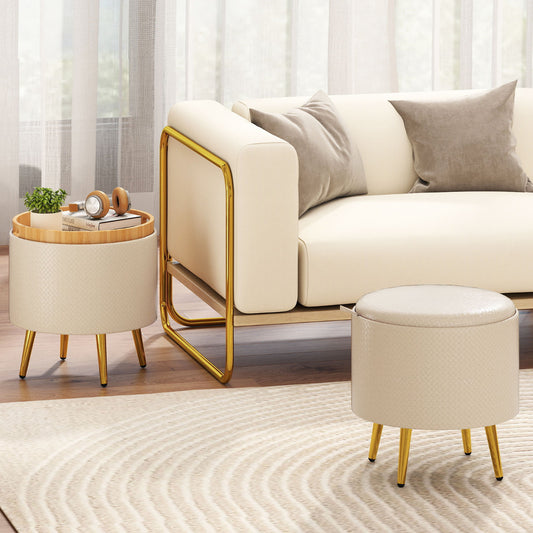 The round footrests placed in a living room next to a cream sofa with gold metal legs