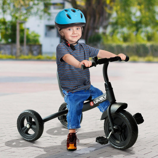 A young boy wearing a blue helmet rides the black children's tricycle on a paved path