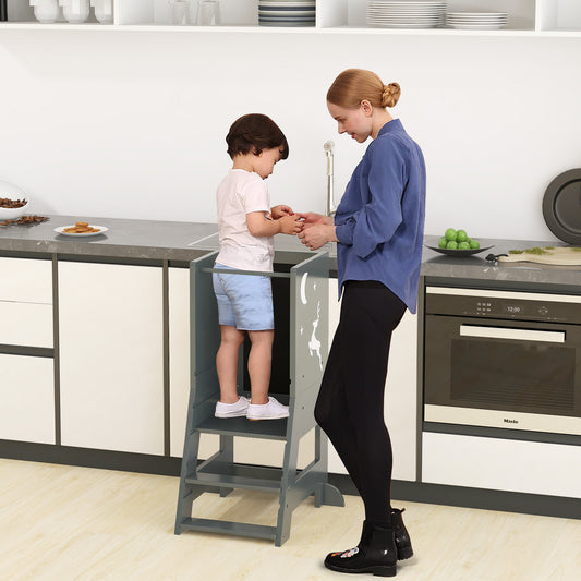 A grey toddler kitchen stool helper with a child standing at counter height