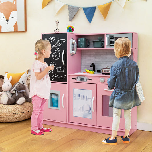 Two young children playing with the pink play kitchen set in a room with decorations