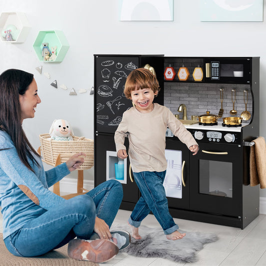 A mother and child playing with the black pretend kitchen playset on a rug