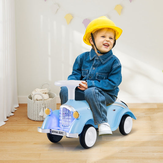 A young child wearing a yellow helmet sitting on the blue ride on toy in a bright room