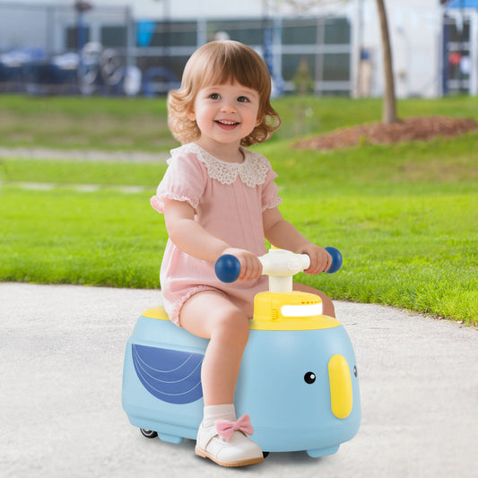 A happy toddler sitting on the blue and yellow elephant ride on toy outdoors