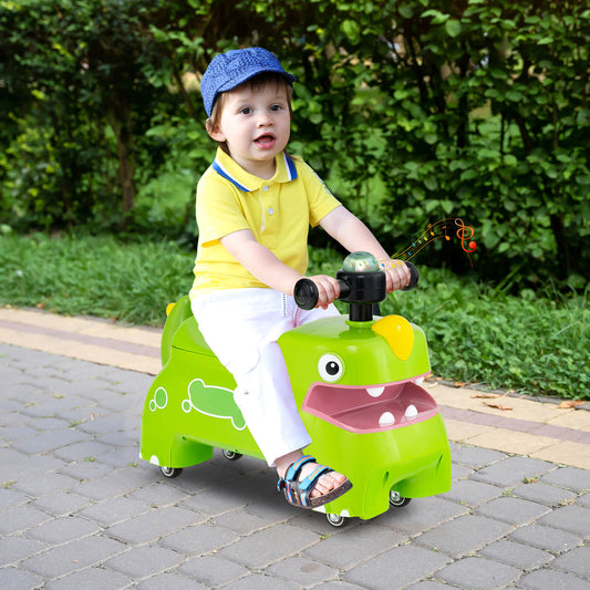The green push and pedal ride on toy being used on a paved path outdoors