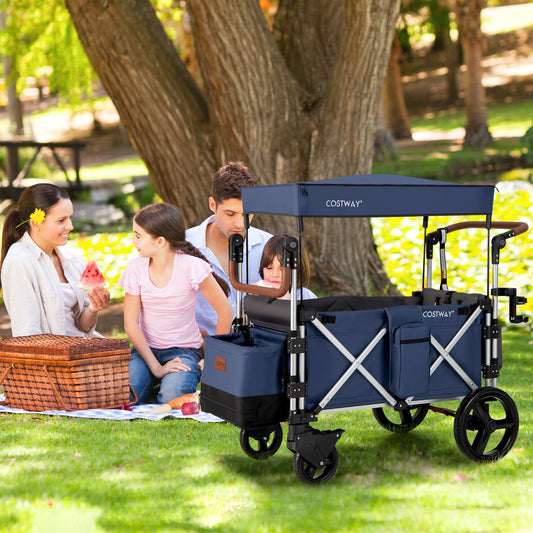 A family having a picnic with the blue double stroller wagon on the grass