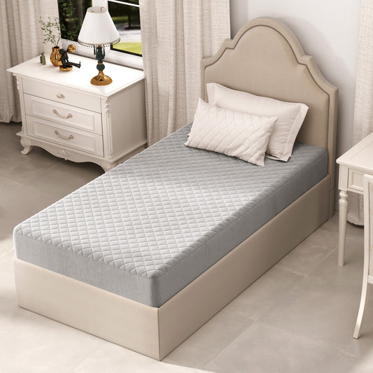 The grey velvet mattress protector fitted onto a single bed in a bedroom setting