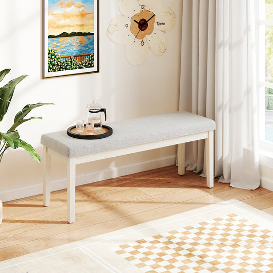 The storage bench placed in a bright living room with a tray and plant nearby