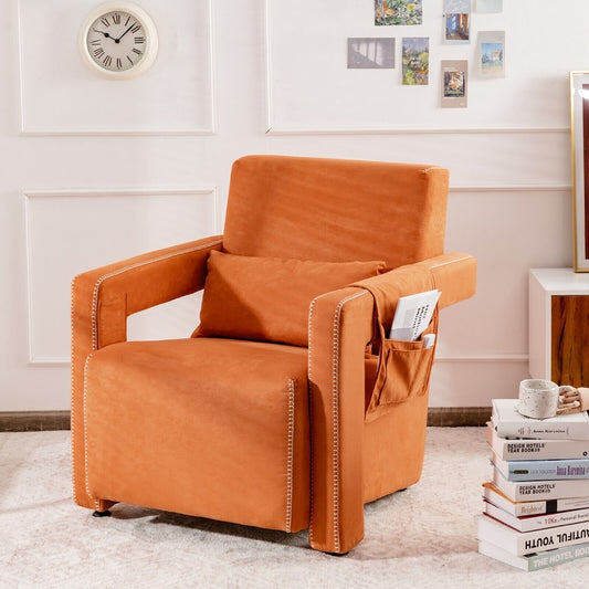 The accent chair placed in a bright living room next to a stack of books and wall decor