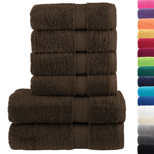 Six brown towels stacked with a selection of other coloured towels beside them