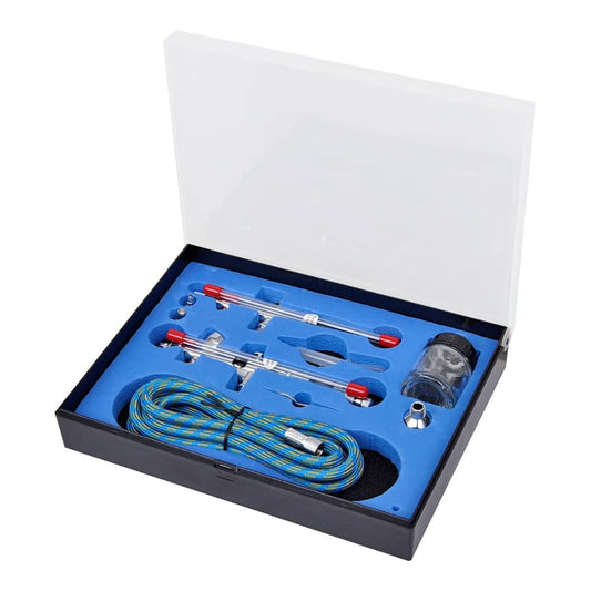 The airbrush set with two spray guns and accessories neatly arranged in its blue foam-lined box