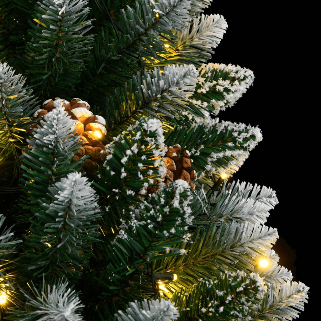 The artificial christmas tree branches featuring snow dusting and natural pine cones