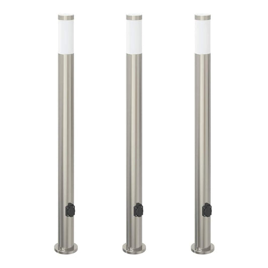 three stainless steel garden lamps standing upright in a row against a plain white background