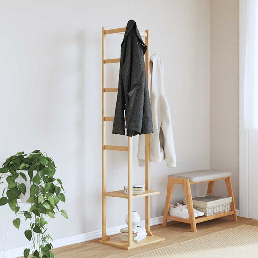 The bamboo coat stand with shelves and hooks in a hallway with coats and a plant