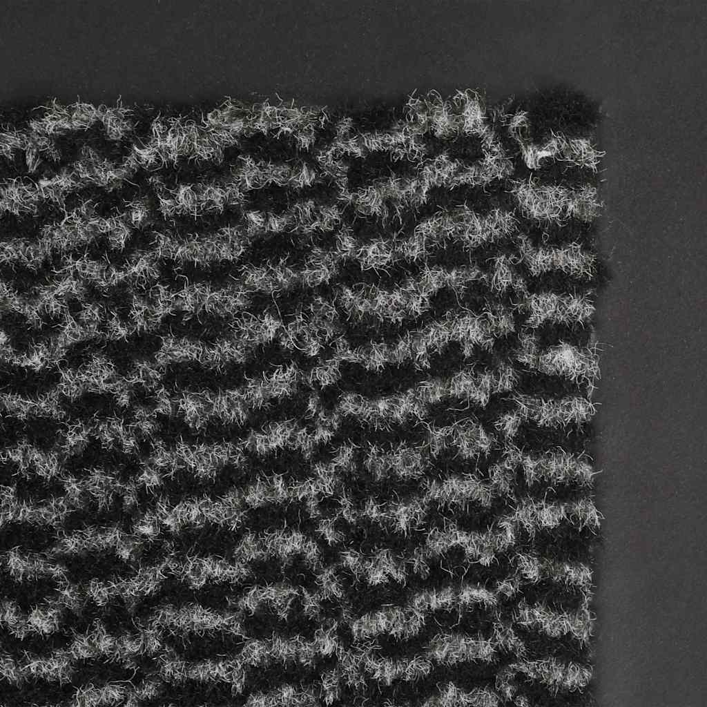 The door mats showing a detailed view of the grey and black tufted fabric texture