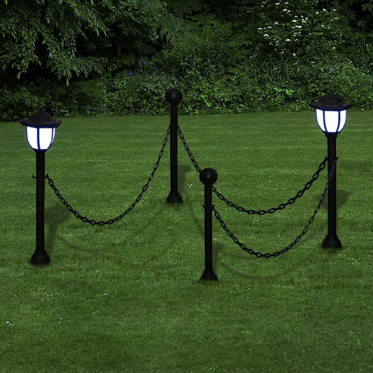 Four solar powered garden lights with chains, set up in a lawn