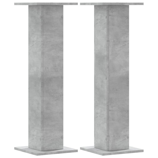 Two concrete grey speaker stands shown from the front