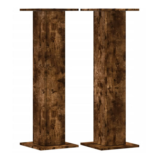 Two tall speaker stands with a wood grain effect, shown from the front