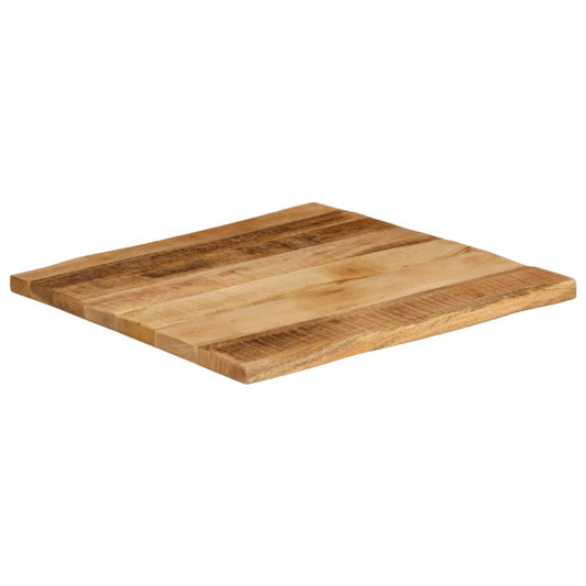 The solid wood rough mango table top shown from a low angle, highlighting its thickness and live edge
