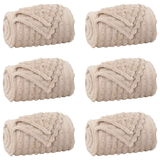 Six beige fleece blankets rolled up and placed side by side