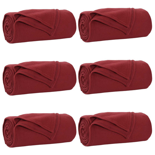 Six bordeaux red fleece blankets rolled up and arranged in two rows