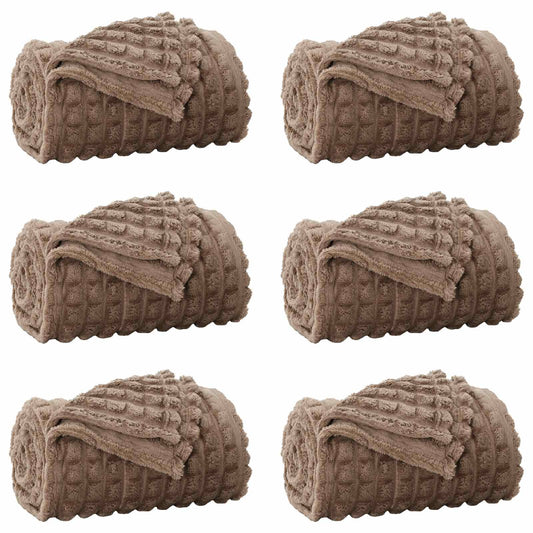 Six camel fleece blankets rolled up and placed side by side