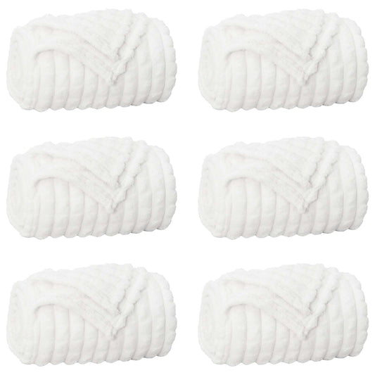 the white blankets arranged in a grid pattern against a plain white background
