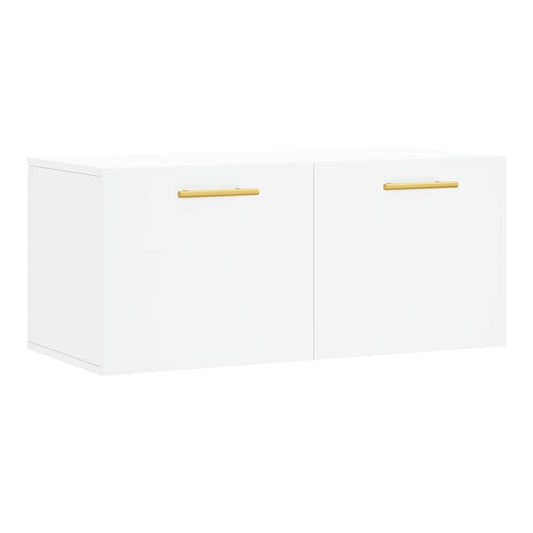 White engineered wood wall cabinet with two gold handles, shown freestanding