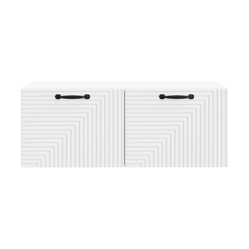 Close-up of the textured front panels and black handles of a white TV cabinet