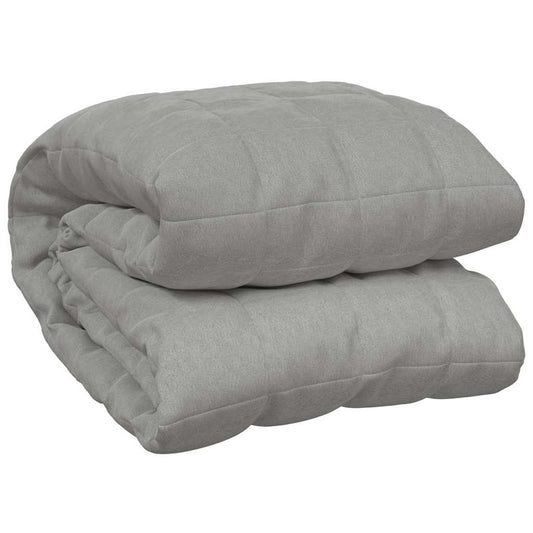 The grey weighted blanket folded neatly on a plain background
